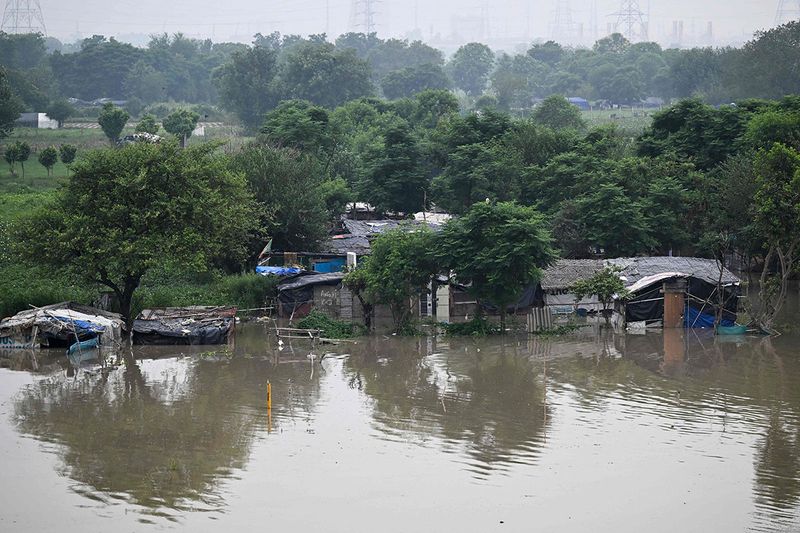 A general view shows a flooded low lying area near the Yamuna River after it overflowed due to monsoon rains in New Delhi on July 11, 2023. 