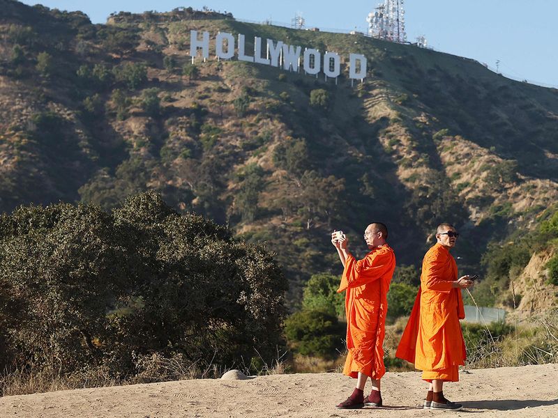 Buddhist monks from Thailand gather and take photos beneath the Hollywood sign as the WGA (Writers Guild of America) strike continues on July 12.