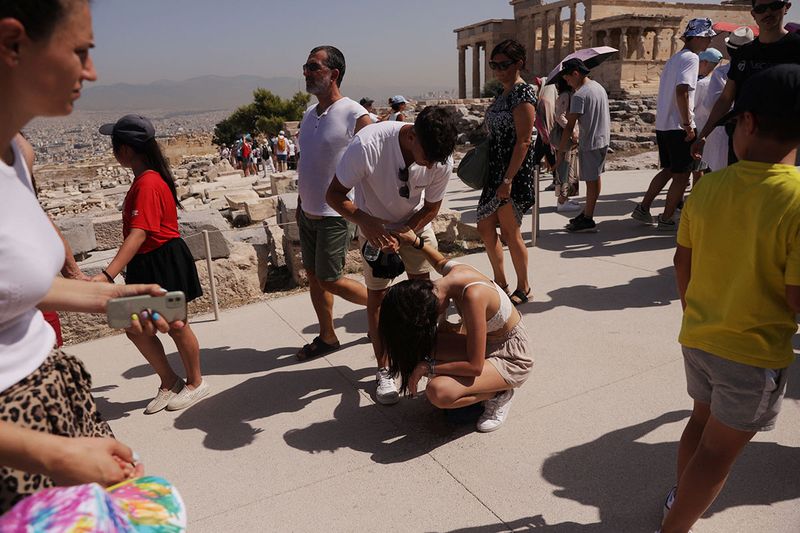 A visitor is affected by the heat atop the Acropolis hill, during a heatwave in Athens, Greece, July 14, 2023. 
