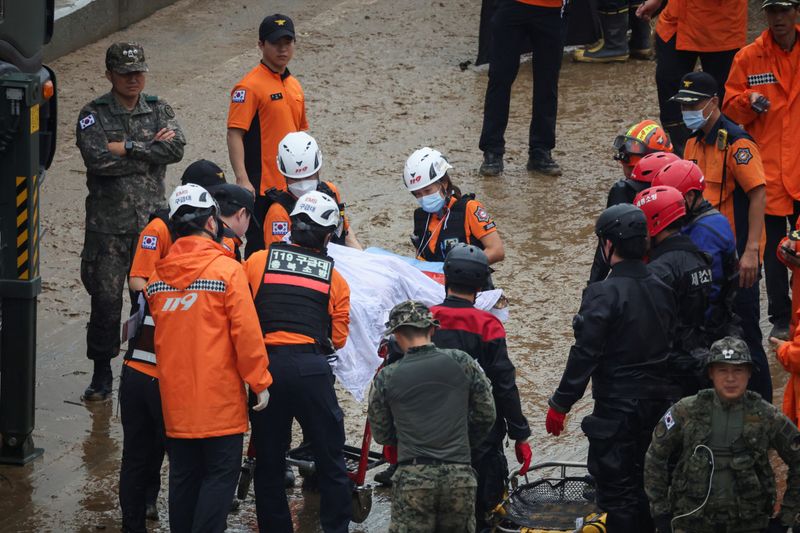 Photos Rescuers retrieve nine bodies from flooded South Korea