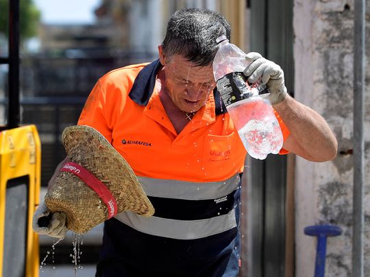 A worker cools off while working in a street during a heatwave in Sevilla, in the southern Spanish region of Andalusia, on July 17, 2023. Scorching weather gripped three continents, whipping up wildfires and threatening to topple temperature records as the dire consequences of global warming take shape. Little reprieve is forecast for Spain, where the met agency warned of a new heatwave on July 17 through July 19 taking temperatures above 40C in the Canary Islands and the southern Andalusia region. 