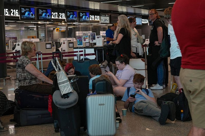 Passengers wait for the check-in of their flights during a nationwide strike of airports ground staff, and check-in services at Rome's Fiumicino International airport in Fumicino, Italy, Saturday, July 15, 2023. 