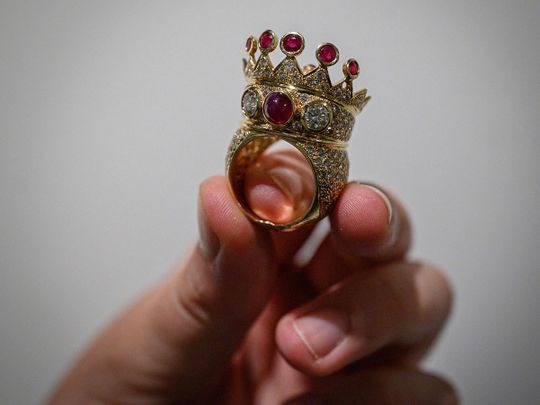  A gold, ruby, and diamond crown ring, designed and worn by the late US rapper Tupac Shakur during his last public appearance in 1996, is displayed during a press preview at Sotheby's in New York City on July 20, 2023. A gold, ruby and diamond crown ring worn by rap legend Tupac Shakur during his last public appearance sold for $1 million at auction in New York on July 25, 2023. The winning bid was well above Sotheby's pre-sale estimate of between $200,000 and $300,000 and becomes the most valuable hip-hop artifact ever sold, the auction house said. 