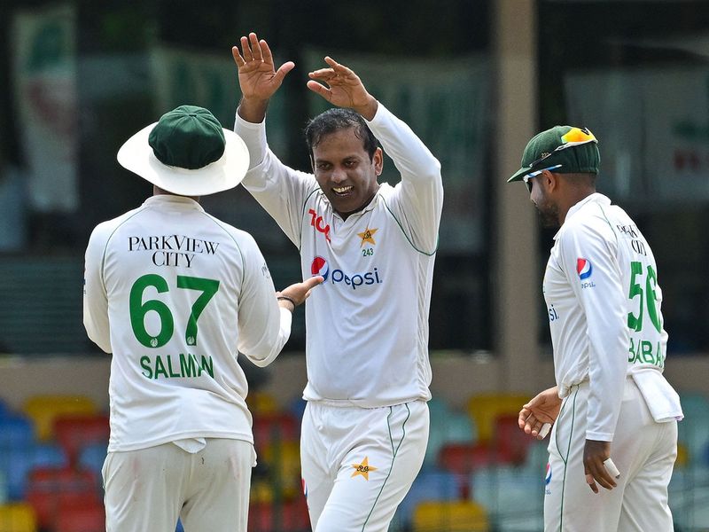 Pakistan's Noman Ali (C) celebrates with teammate Salman