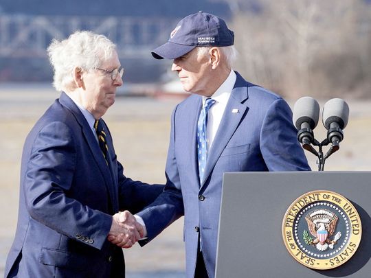 US President Joe Biden shakes hands with US Senate Republican Leader Mitch McConnell. 