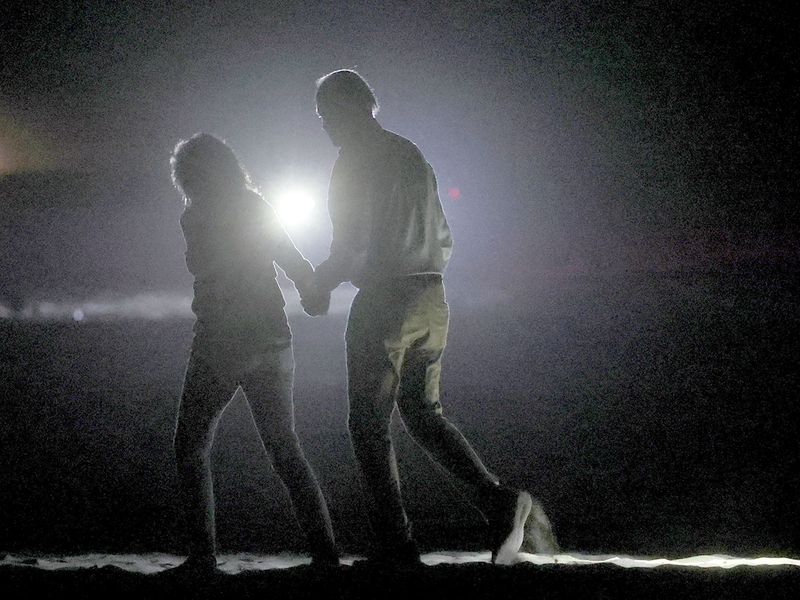 Joe Biden and first lady Jill Biden have a short walk on the beach after having dinner and seeing Oppenheimer in Rehoboth Beach, Delaware. 