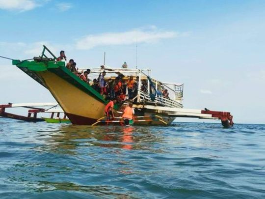 Rescued passengers arrive on a boat in Polillo, Quezon province, northeastern Philippines on Thursday Aug. 3, 2023. 