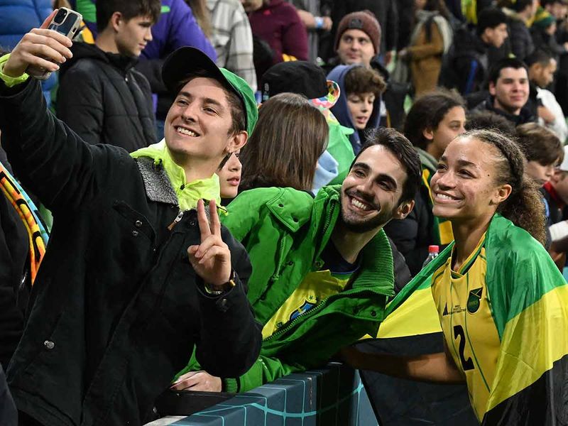 Jamaica's midfielder #02 Solai Washington poses for a selfie with fans after her team qualified for the last 16 following the Australia and New Zealand 2023 Women's World Cup Group F football match between Jamaica and Brazil at Melbourne Rectangular Stadium, also known as AAMI Park, in Melbourne on August 2, 2023.