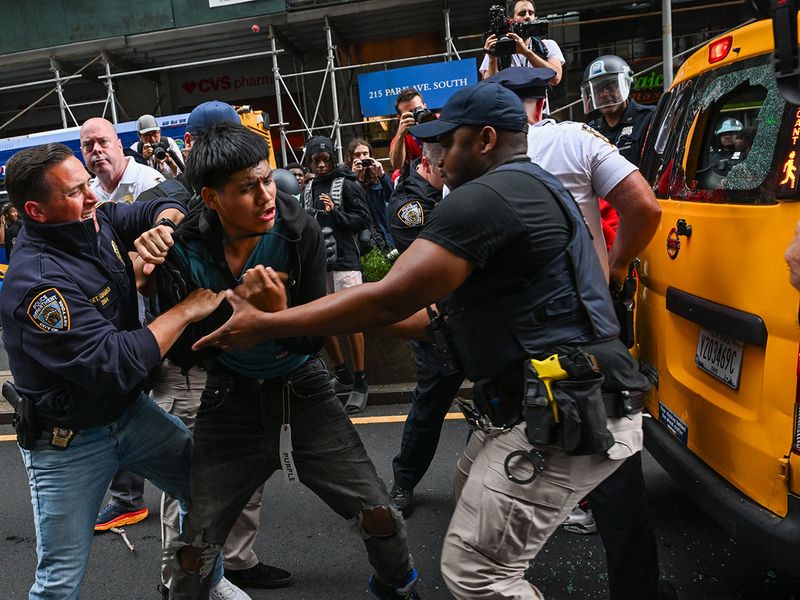 Members of the NYPD respond to the disruptions caused by large crowds during a 