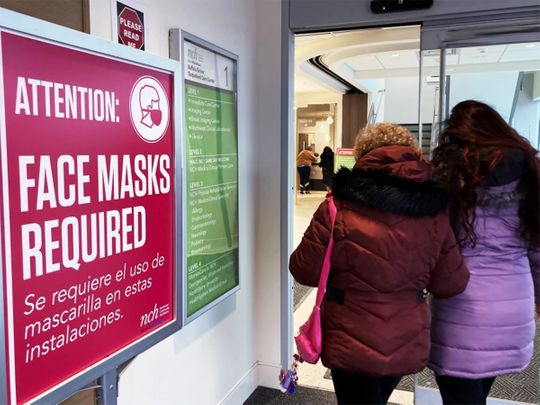 A sign announcing a face mask requirement is displayed at a hospital in Buffalo