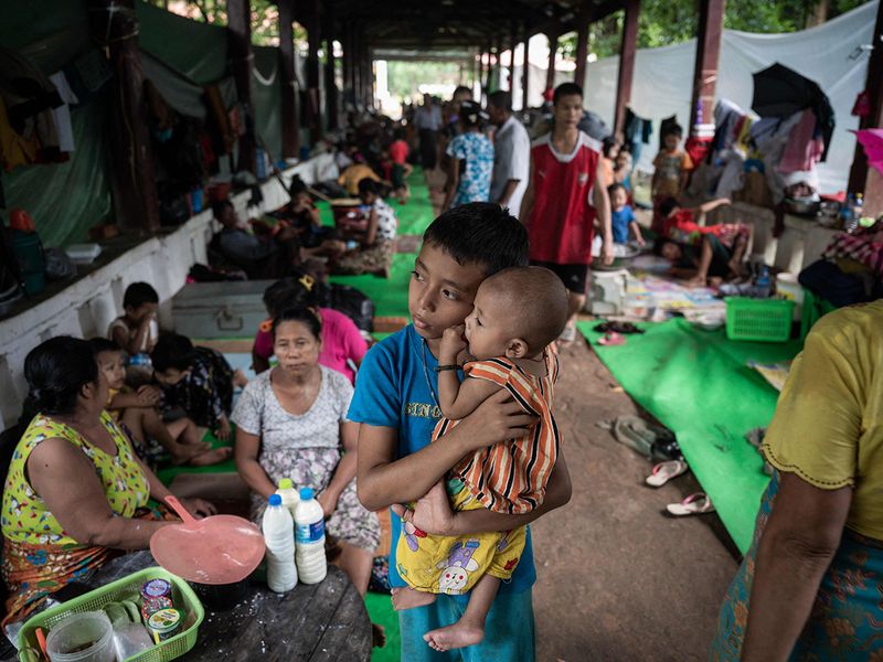 Residents displaced by flooding take shelter in a monastery compound following monsoon rains in Bago township on August 12, 2023.  