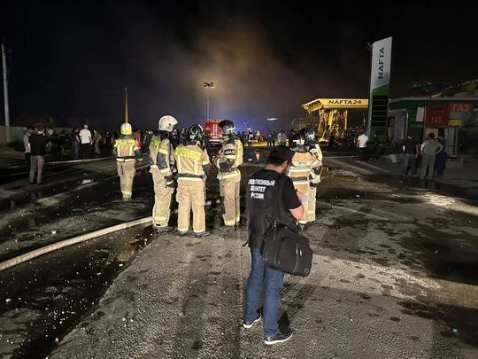 This handout photograph taken and released by Russian Investigative Committee on August 15, 2023, shows rescuers working at the site of a blast at a gas station in the city of Makhachkala. 