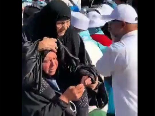 Woman carries mother on shoulder prayer prophet's mosque saudi