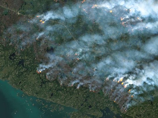 This handout satellite image courtesy of the European Space Agency's (ESA) Copernicus Sentinel-2 sattelite taken on August 16, 2023 shows fires burning in Yellowknife, Northwest Territories, Canada.