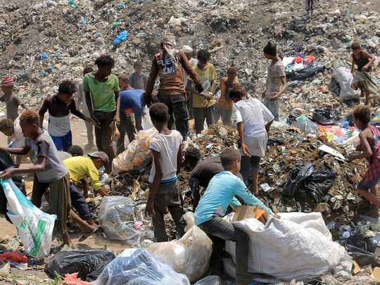 Youths collect recyclable items at a garbage dump in Yemen's Red Sea port city of Hodeida.  