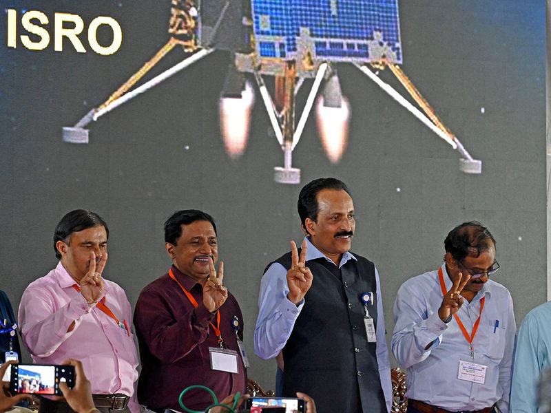 ISRO Chairman S. Somanath with others show victory sign after the successful soft-landing Chandrayaan-3 Lander Vikram on the surface of Moon during Chandrayaan-3 Mission, at ISRO in Bengaluru on Wednesday. 