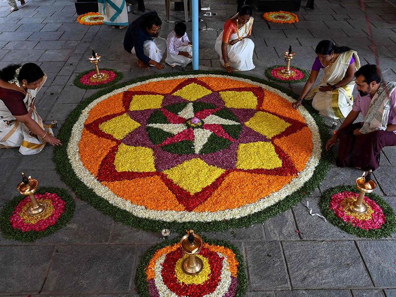 Devotees prepare Pookalam, a traditional floral arrangement