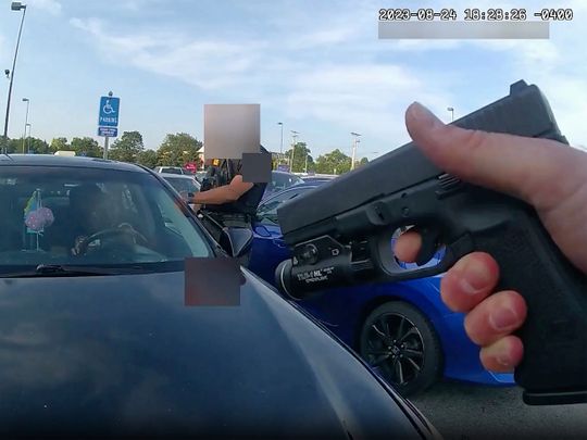 This still image from bodycam video released by the Blendon Township Police on Friday, September1, 2023, shows an officer pointing his gun at Ta’Kiya Young moments before shooting her through the windshield outside a grocery store in Blendon Township, Ohio, a suburb of Columbus, on August 24. 