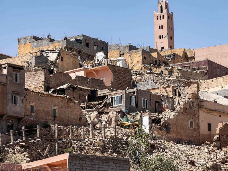 The minaret of a mosque stands behind damaged or destroyed houses following an earthquake in Moulay Brahim, Al-Haouz province, on September 9, 2023. 