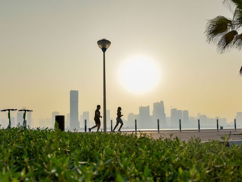 People jog during early hours in Dubai with the foreground of greenery in Dubai on August 23, 2023. Photo: Ahmed Ramzan/Gulf News