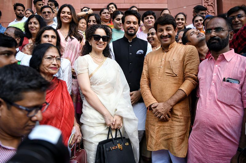 Bollywood actress Kangana Ranaut with Union Minister for Information and Broadcasting Anurag Singh Thakur, BJP MP Manoj Tiwari and other MPs outside the new Parliament Building, in New Delhi on Tuesday. 