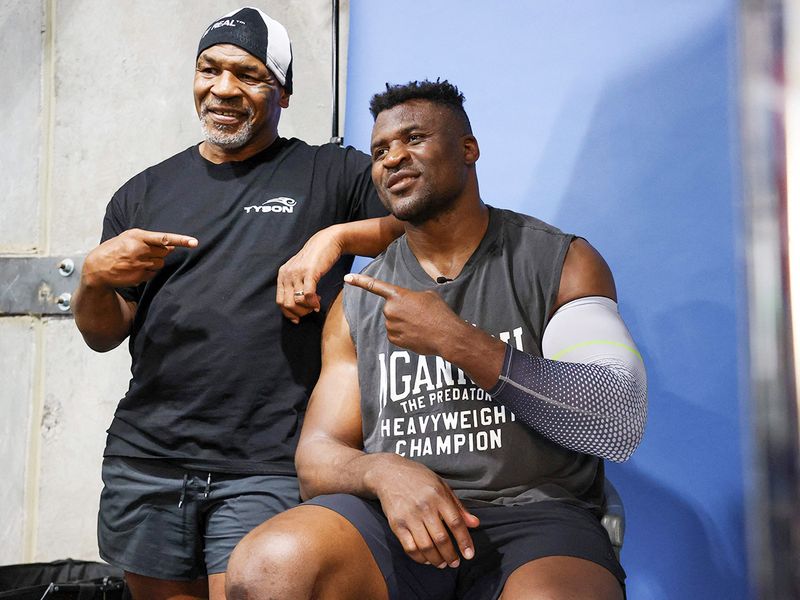 Former US boxer Mike Tyson (L) and Francis Ngannou