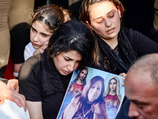 Mourners attend the funeral of victims who were killed when a fire ripped through a crowded wedding hall in the northern city of Qaraqosh, also known as Hamdaniyah, on September 27, 2023.  
