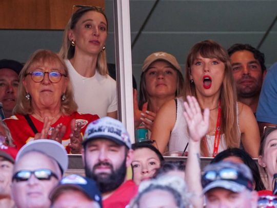 Taylor Swift reacts while watching an American football game.