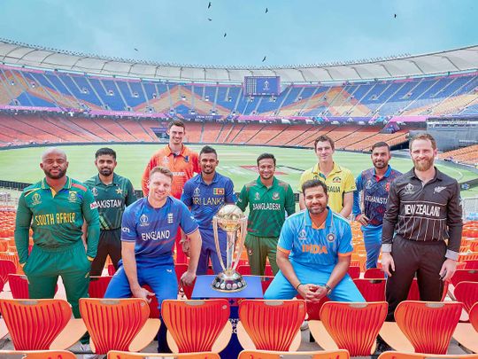 Team captains pose for a picture with the ICC Cricket World Cup trophy 