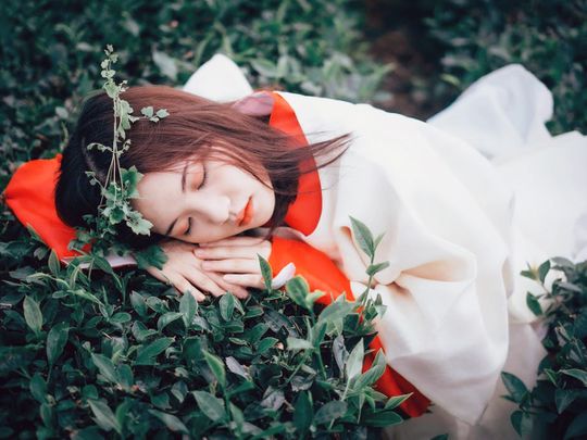 Woman sleeping on leaves