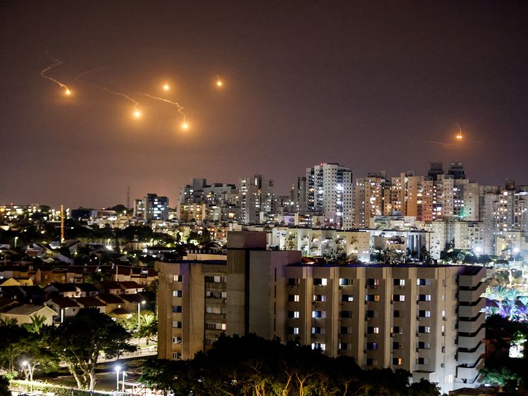 Flares illuminate the sky over northern Gaza, as seen from Ashkelon, southern Israel October 7, 2023. 