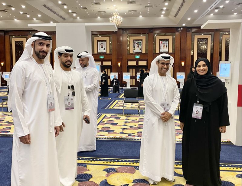 Mohammed Hamad Al Kuwaiti (second from right) and Essa Mohammed Khalifa Al Mutaiwei (first from left) with other other officials at Dubai’s main polling centre in Dubai World Trade Centre during the former-1696690106062