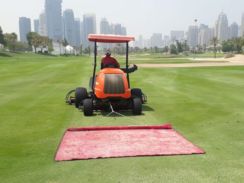 Sport - Golf - Emirates Golf Club - Carpet is attached to fairway mowers