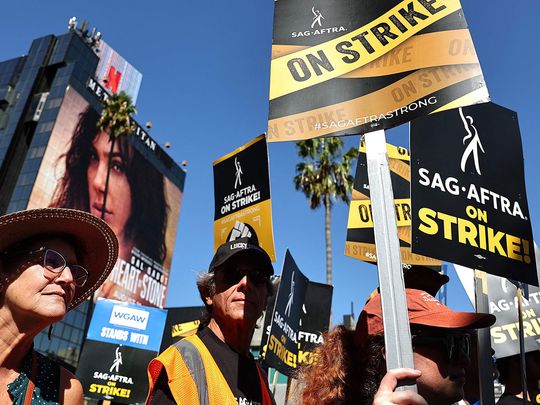 SAG-AFTRA members and supporters picket outside Netflix studios on day 91 of their strike against the Hollywood studios on October 12, 2023 in Los Angeles, California. Contract negotiations between SAG-AGTRA and the Alliance of Motion Picture and Television Producers (AMPTP) were suspended yesterday. The strike began July 14.   Mario Tama/Getty Images/AFP