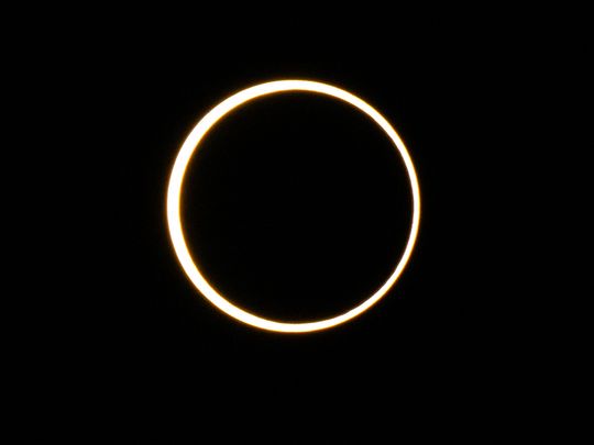 The moon descends over the sun's horizon during an annular solar eclipse on October 14, 2023 in Kerrville, Texas. Differing from a total solar eclipse, the moon in an annular solar eclipse covers part of the sun's light, creating the 
