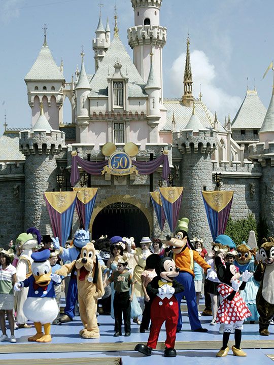 Disney characters led by (L-R) Donald Duck, Pluto, Mickey Mouse, Goofy and Minnie Mouse stand on stage in front of Sleeping Beauty Castle for the announcement of the celebration planned for the 50th anniversary of the Disneyland theme park, at Disneyland in Anaheim, California May 5, 2004. The park, the dream project of Walt Disney opened July 17, 1955.