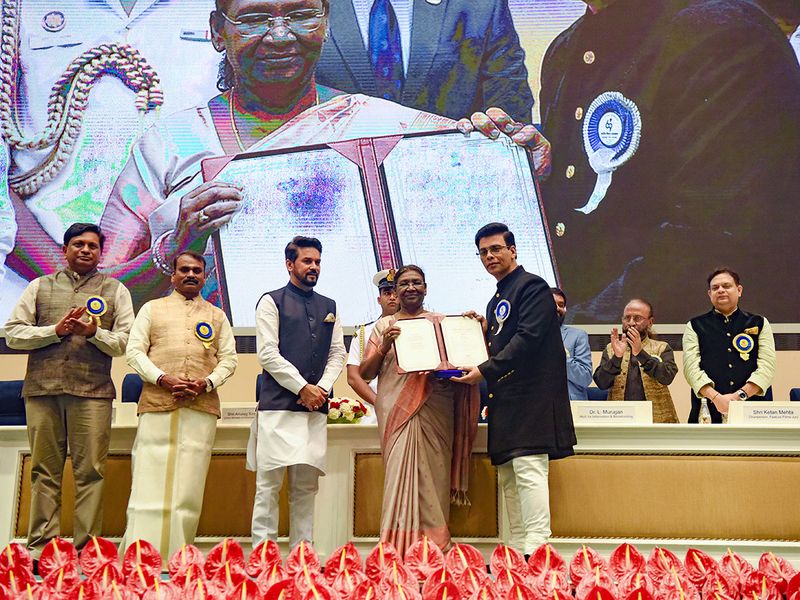 President Droupadi Murmu presents the National Award to Bollywood filmmaker Karan Johar for the film 'Shershaah' during the 69th National Film Awards, in New Delhi on Tuesday.