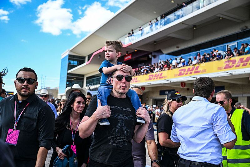 SpaceX CEO Elon Musk with one of his son walks on the pit lane after the 2023 United States Formula One Grand Prix at the Circuit of the Americas in Austin, Texas, on October 22, 2023. 