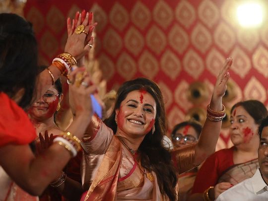Bollywood actress Rani Mukerji (C) dances on the last day of the 'North Bombay Sarbojanin Durga Puja' festival in Mumbai on October 24, 2023.