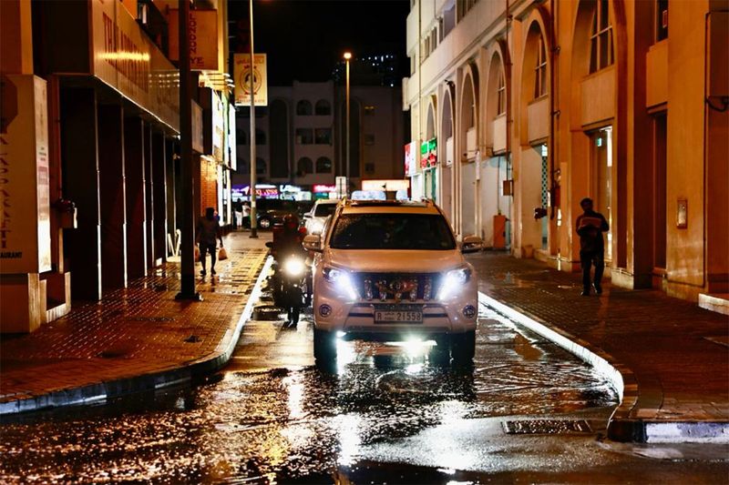 Traffic comes to a crawl as motorists navigate through rain puddles around Dubai. 