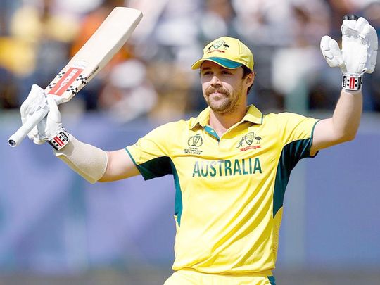 Australia's Travis Head raises his bat as he celebrates his century