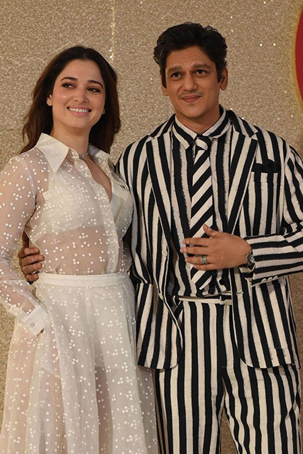 Bollywood actor Vijay Varma (R) and Tamannaah Bhatia (L) walk the ramp for the launch of the 'Jio World Plaza' mall in Mumbai on October 31, 2023. (Photo by SUJIT JAISWAL / AFP)