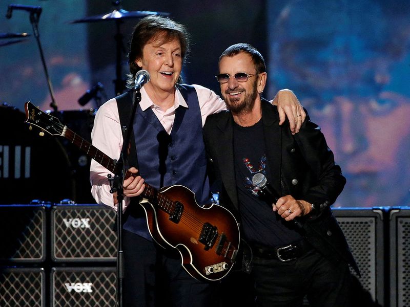 Paul McCartney (L) and Ringo Starr perform during the taping of 