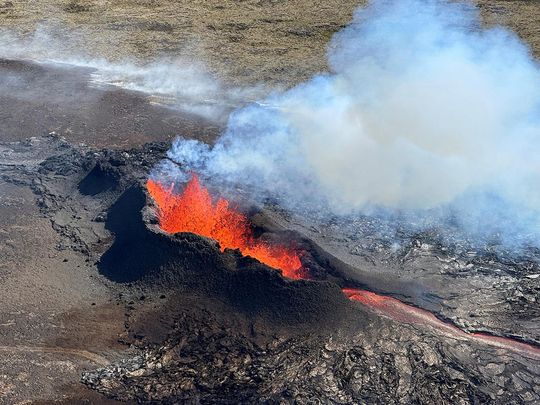 Lava spurts and flows after the eruption of a volcano in the Reykjanes Peninsula