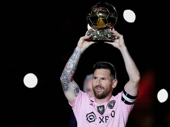 Lionel Messi of Inter Miami CF hoist his trophy during the Ballon d'Or trophy presentation 