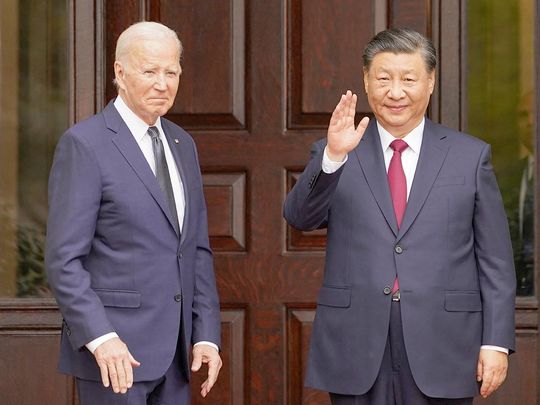 Chinese President Xi Jinping waves as he meets with US President Joe Biden 