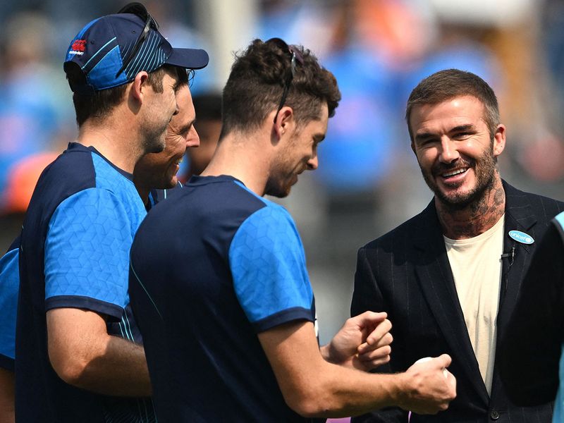 Former English football player David Beckham (R) interacts with New Zealand's players before the start of the 2023 ICC Men's Cricket World Cup one-day international (ODI) first semi-final match between India and New Zealand at the Wankhede Stadium in Mumbai on November 15, 2023. (Photo by Punit PARANJPE / AFP) / -- IMAGE RESTRICTED TO EDITORIAL USE - STRICTLY NO COMMERCIAL USE --