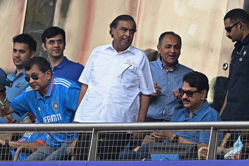 Reliance Industries billionaire Mukesh Ambani (C) at the match. 