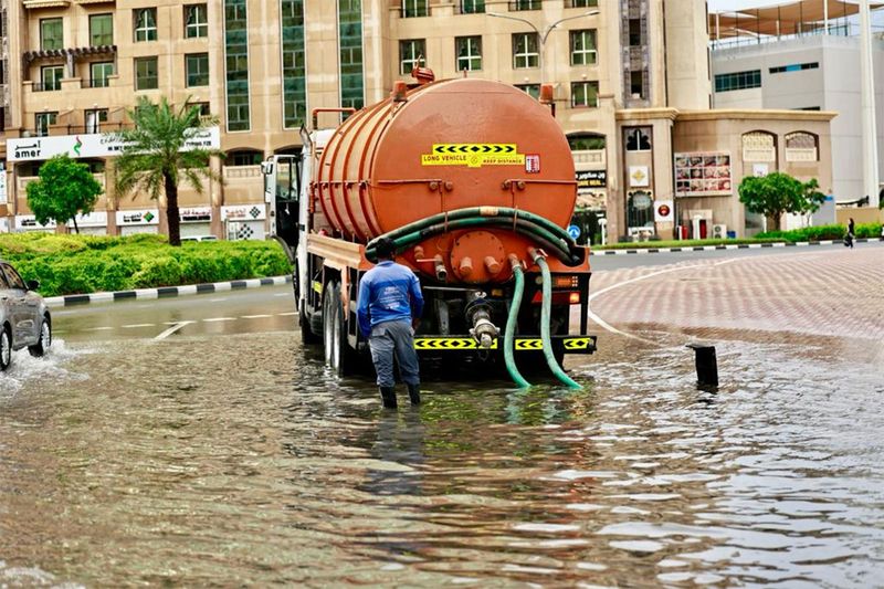 Municipality workers opens the blocked drainage due to water logging during in Dubai.