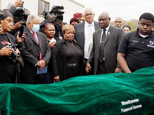 Surrounded by family members and holding hands with civil rights attorney Ben Crump, center right, Bettersten Wade, centre, mother of Dexter Wade, a 37-year-old man who died after being hit by a police SUV driven by an off-duty officer, watches her son's body transferred to a mortuary transport in Raymond, Mississippi, on November 13, 2023. 